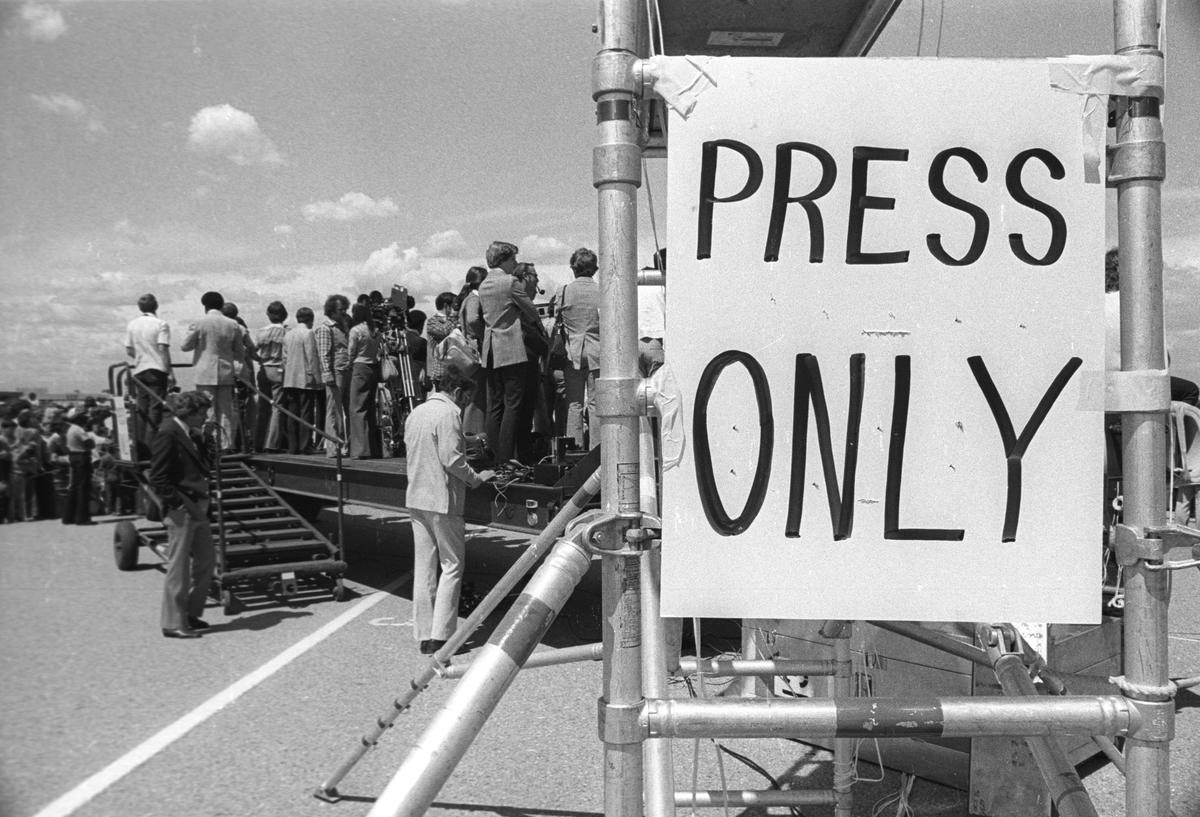 The press wait for President Jimmy Carter to arrive in Fresno to talk about the drought on a day trip to California.