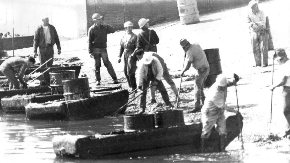 Workers clean a beach after the Union Oil disaster near Santa Barbara on Feb. 15, 1969. A casing break fractured the sea floor and the oil spill went on for months in the Santa Barbara Channel.