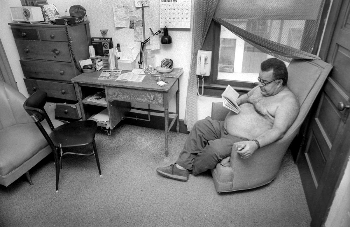 Park Hotel resident manager Roland Wilson reads in his room in 1982. Before the San Luis Obispo hotel was remodeled, there were 42 small rooms with shared bathrooms, without kitchen or elevator.