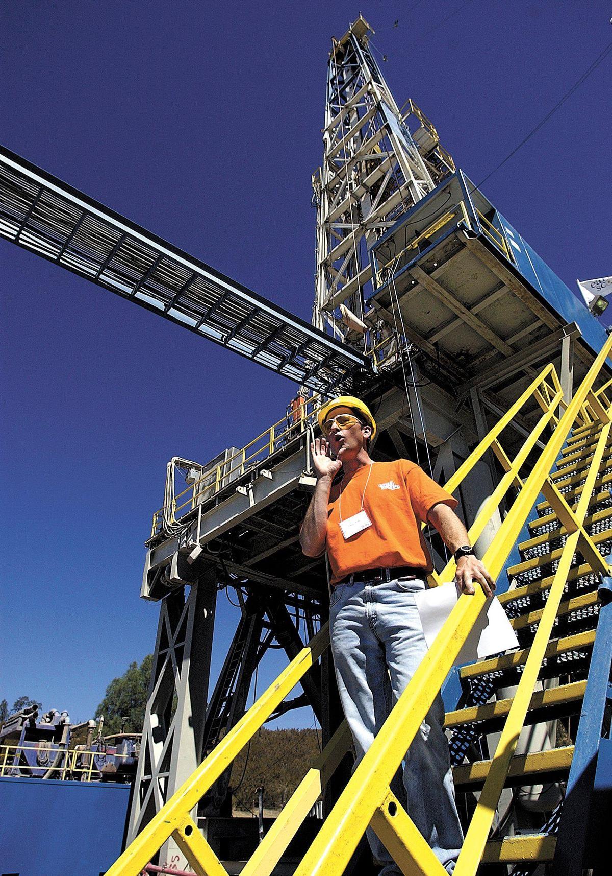 Chris Walls, with the Southern California Plate Boundary Observatory, gathers his media group together as he gets ready to take them up to the drill platform during a tour of EarthScope’s San Andreas Fault Observatory at Depth drill platform and research site in 2004.