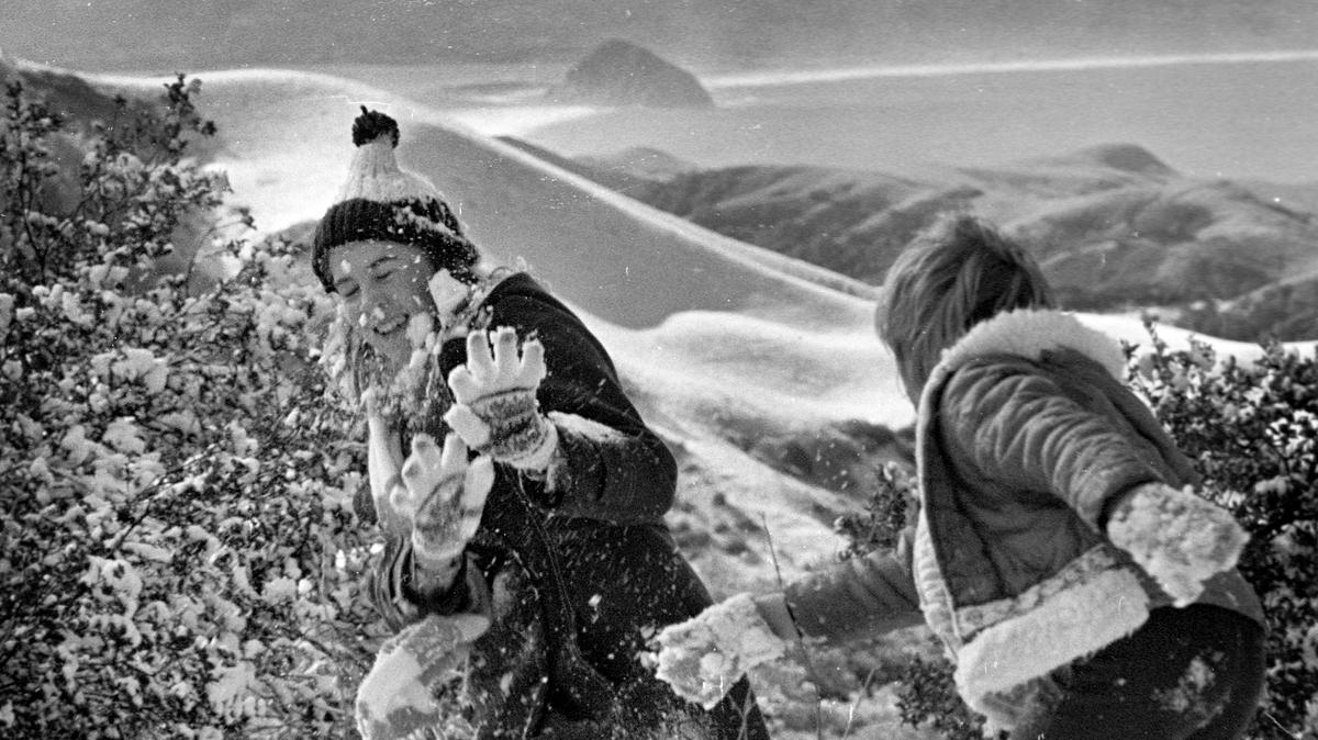 Laura Peterson, left, and Brandee Leonhardt, both of Morro Bay have snowfight on Highway 46 six miles west of Cambria. Photo by Thom Halls. 3-3-1976