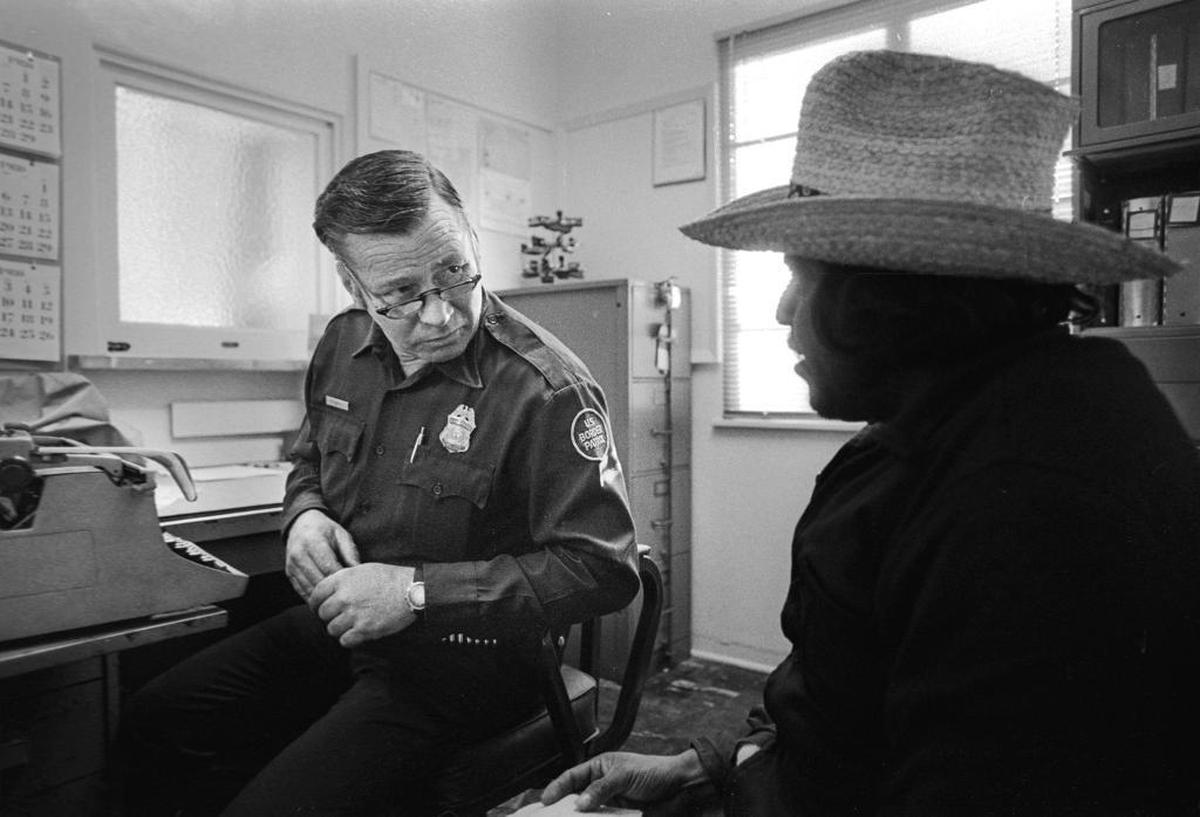 Border Patrol Officer Edward Tuffly gets information from Jesus Ramirez Rivera at the office in San Luis Obispo.