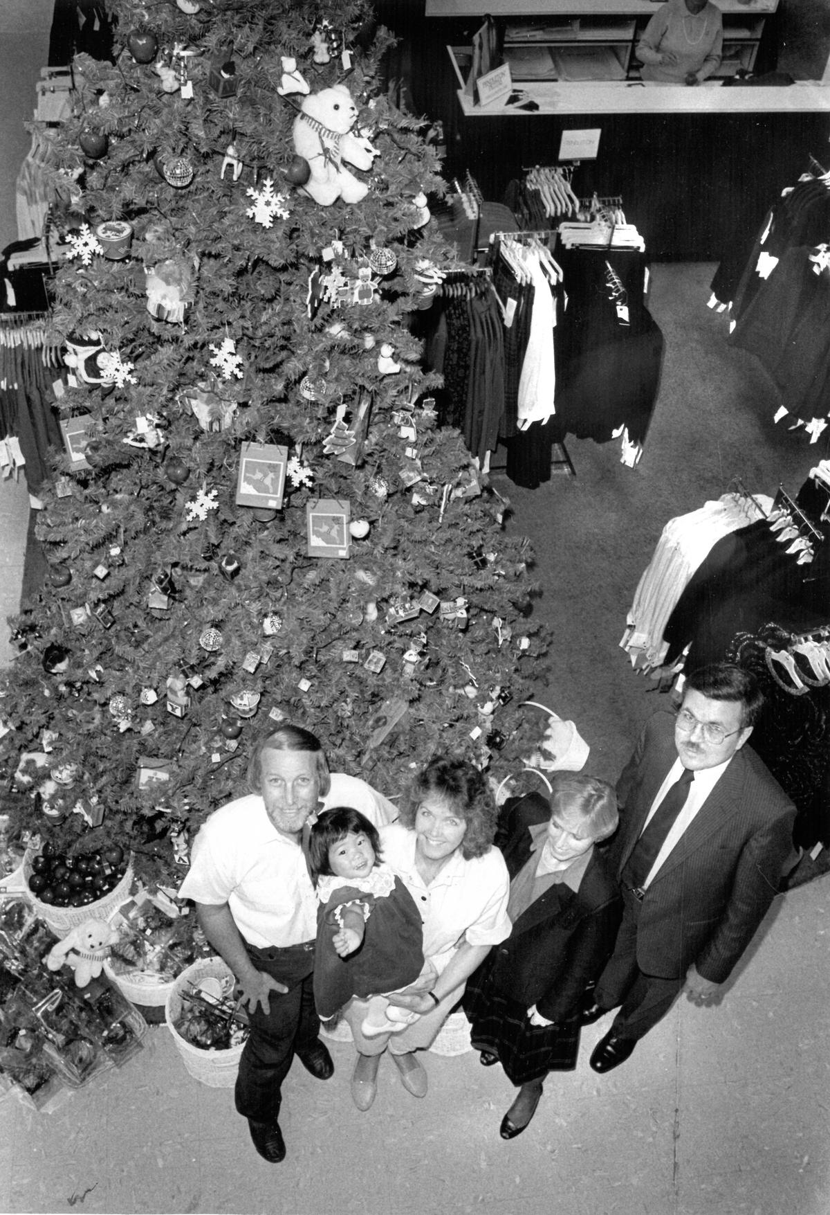 From left, Clyde, Nicole and Carol Harrell with Sharon Glick and Don Adams by Rileys tree. The Glicks adoption was assisted by the Children’s Home Society, a charity that Rileys supported. David Middlecamp 12-21-1987