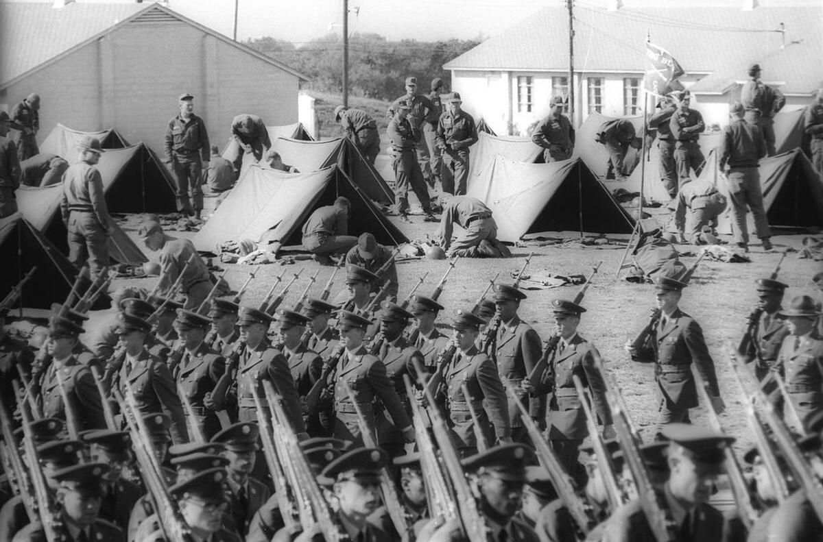 Fort Ord training for San Luis Obispo County recruits. Soldiers march past pup tents at the Monterey area training facility Oct. 16, 1966.