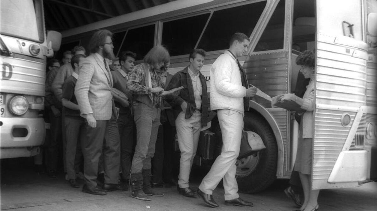 Mrs. B.L. Durham, San Luis Obispo County Draft Board clerk, checks 109 draftees aboard a Greyhound special on Jan. 26, 1966. They were bound for their physicals in Los Angeles.
