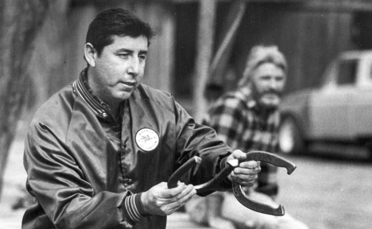 Mike Garcia takes aim at horseshoe pit outside Pozo Saloon in 1987.