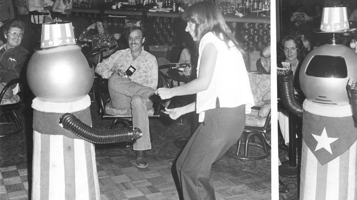 John C.W. Shoop’s Orion robot celebrates his reprieve from “jail” at a party at Trader Nick’s in Pismo Beach on Aug. 24, 1978, dancing with Shyer Pitt of Shell Beach and doffing his hat, right.
