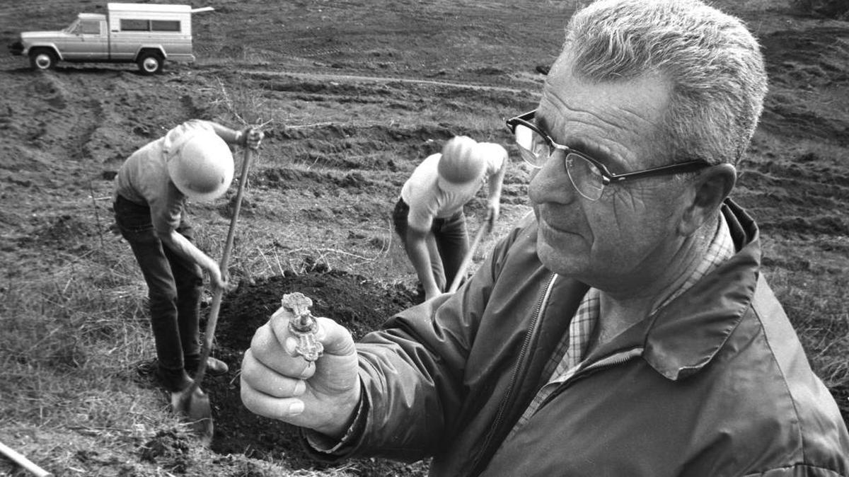 Earl Wood from Wood Funeral Home holds a religious emblem found in a grave in 1967 during construction of the Lopez Dam. The grave in Lopez Canyon was marked “La Maria, 1899.” The remains were moved to Arroyo Grande District Cemetery.