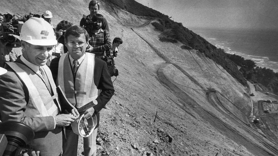 Gov. George Deukmejian, in hard hat, and Assemblyman Eric Seastrand are surrounded by press on March 13, 1984, during a tour of the massive Big Sur slide near Julia Pfeiffer Burns State Park.