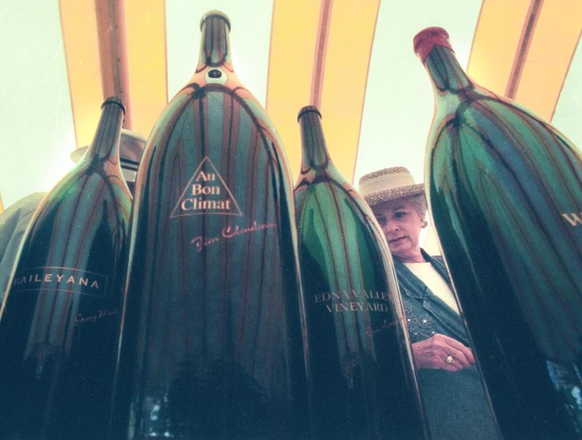 Gladys Burow views auction items before the KCBX wine auction at Avila Resort on Saturday July 13, 1996.