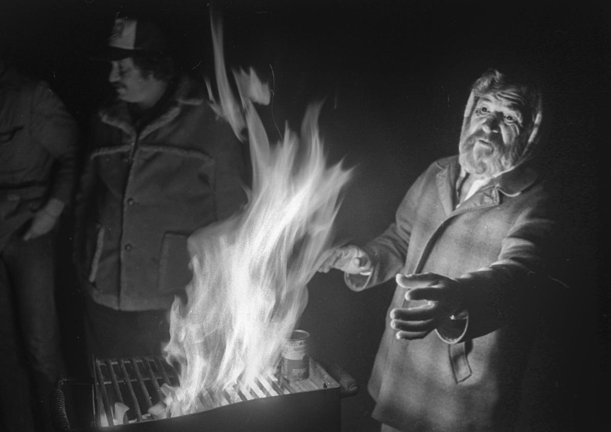 Wild Child heats up a can of mushroom soup on a grill at El Chorro Regional Park as Zedakah House bus riders celebrate their last night together in 1988.