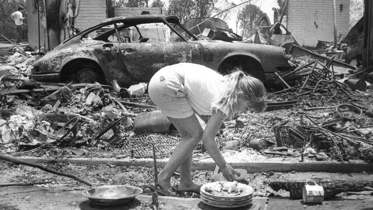 Laura Petrini, 8, salvages plates and cups from the ruins of her family’s home in the Rancho San Antonio area near Santa Barbara in the aftermath of the 1990 Painted Cave Fire.