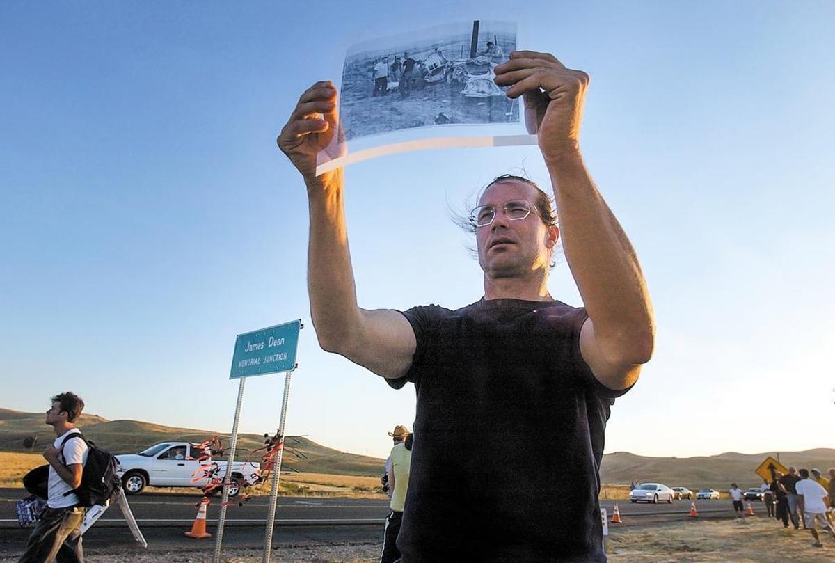 Rick Young of Los Angeles closes one eye and tries to line up a photographic transparency of the James Dean accident with the hills above James Dean Junction, on Sept. 30, 2005. This was the 50th anniversary of the fatal crash.