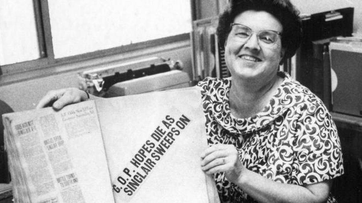 SLO County librarian Lois Crumb shows off a scrapbook on Upton Sinclair that was donated in 1969.