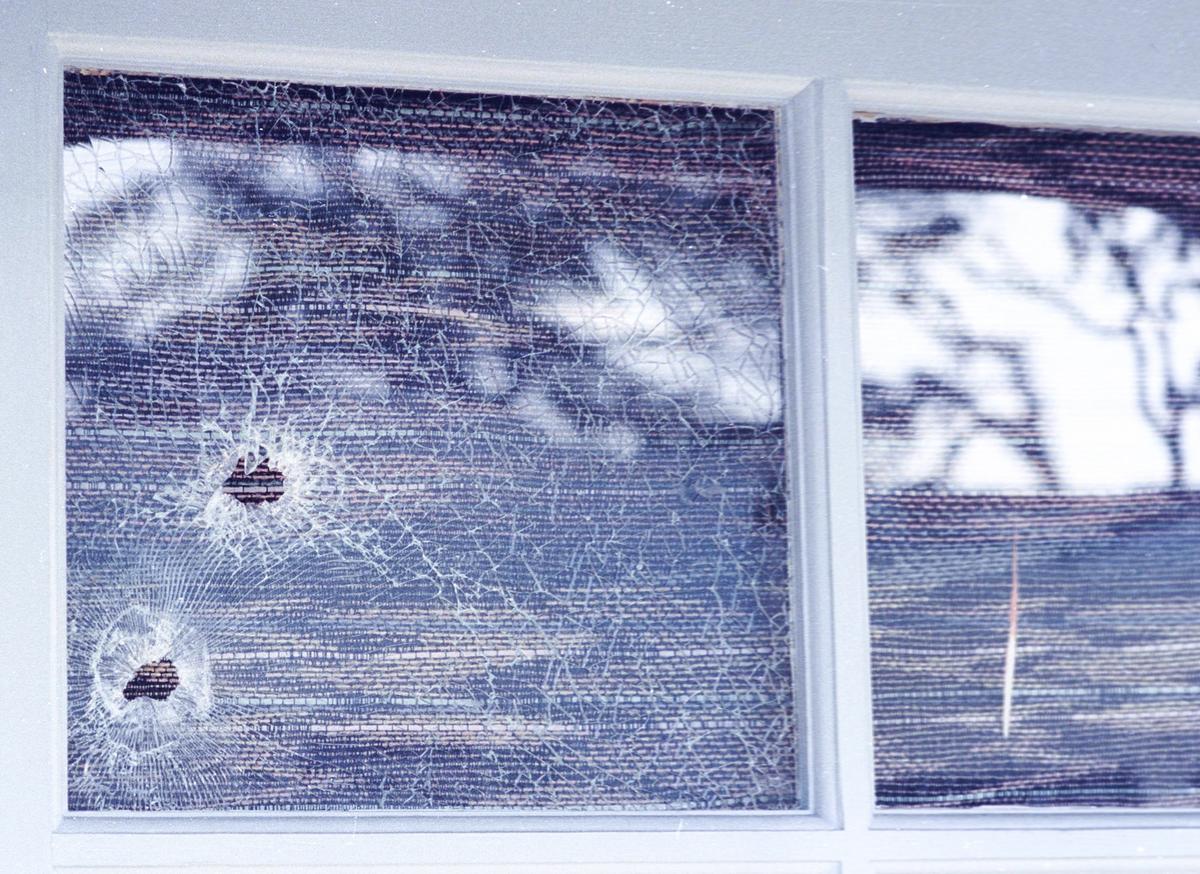 Bullet holes can be seen in the door of the Oak’s Card Parlour in Paso Robles, where three people were murdered by Lynwood Drake III in 1992.