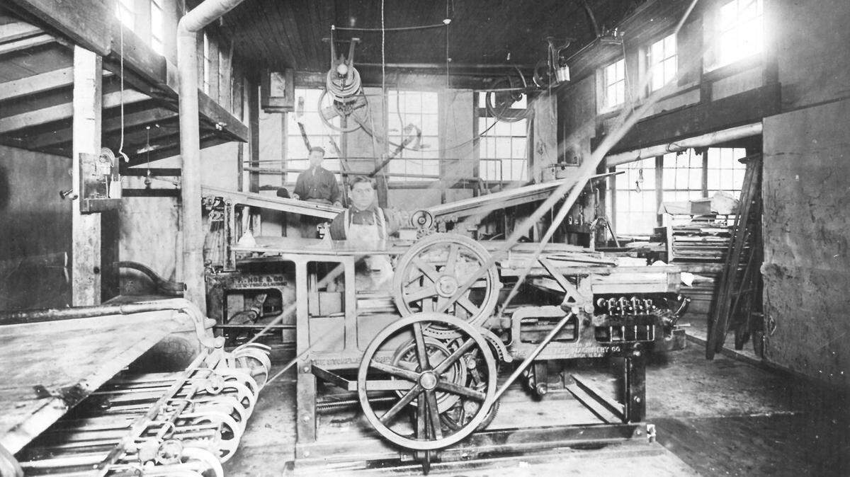 This was the old Tribune press room when it was located on Chorro Street in San Luis Obispo.. At the press in the foreground is Manuel Herrera, San Luis Obispo constable. In the rear is James Serrano. The picture was taken about 1900.