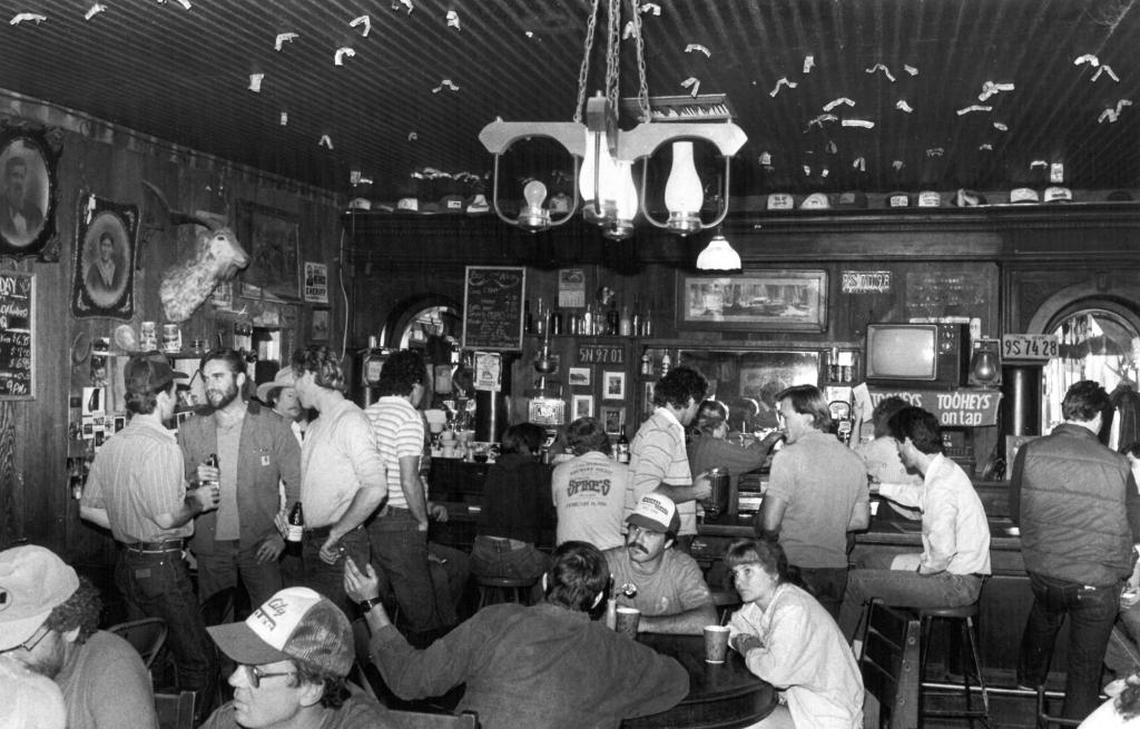 Dollar bills decorate the ceiling of the Pozo Saloon in a photo from 1987. The redwood building was constructed in 1858.