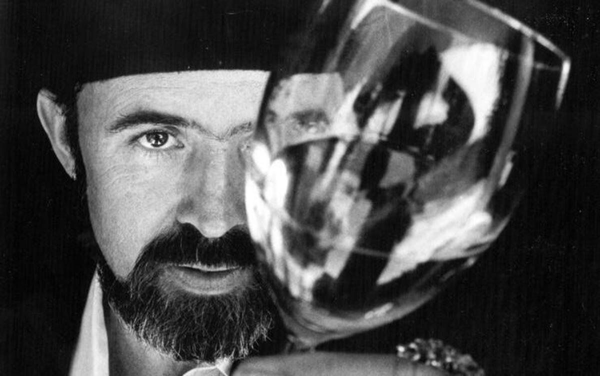 Archie McLaren, organizer of the Central Coast Wine Classic, checks a wine for color in August 1986.
