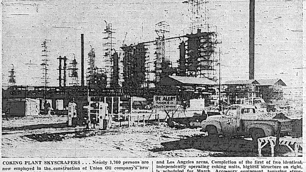 The original cutline from the Telegram-Tribune read as follows: COKING PLANT SKYSCRAPERS ... Nearly 1,700 persons are now employed in the construction of Union Oil company's new coking plant southwest of Arroyo Grande. Some 3,200 acres of unproductive sand dunes are being converted into an industrial plant for manufacturing coke, sulphur and high grade feed stock gas oils for use in big Union Oil refineries in the San Francisco and and Los Angeles areas.Completion of the first of two identical independently operating coking units, highest structure on right, is scheduled for March. Caesar equipment, towering structures surrounding the two coking units, includes gas-fired heaters, heat exchangers, fractionalization columns for separating gases, and liquids, condensers, after-coolers and multiple stage pumps, Bechtel corporation is building the $5,000,000 plant.