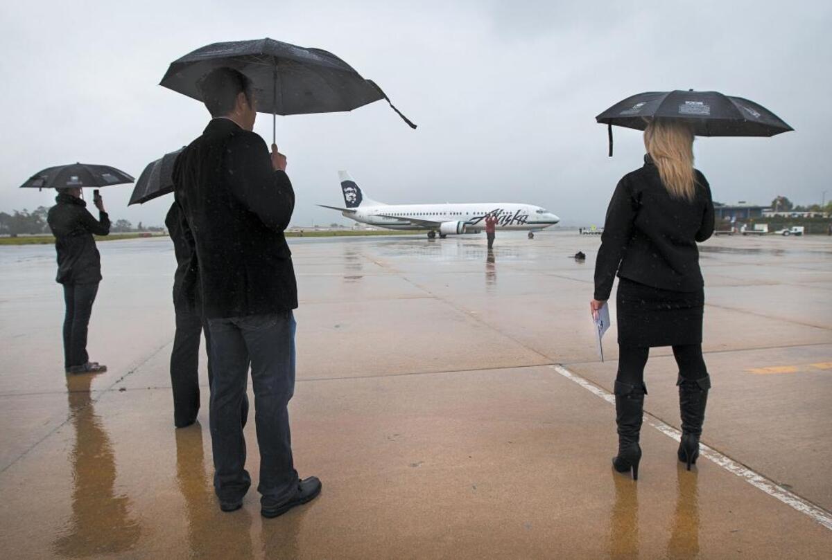 2009: Spectators watch as a Boeing 737-400 carrying the San Francisco Symphony taxis into position after landing at the San Luis Obispo airport on Jan. 23, 2009.