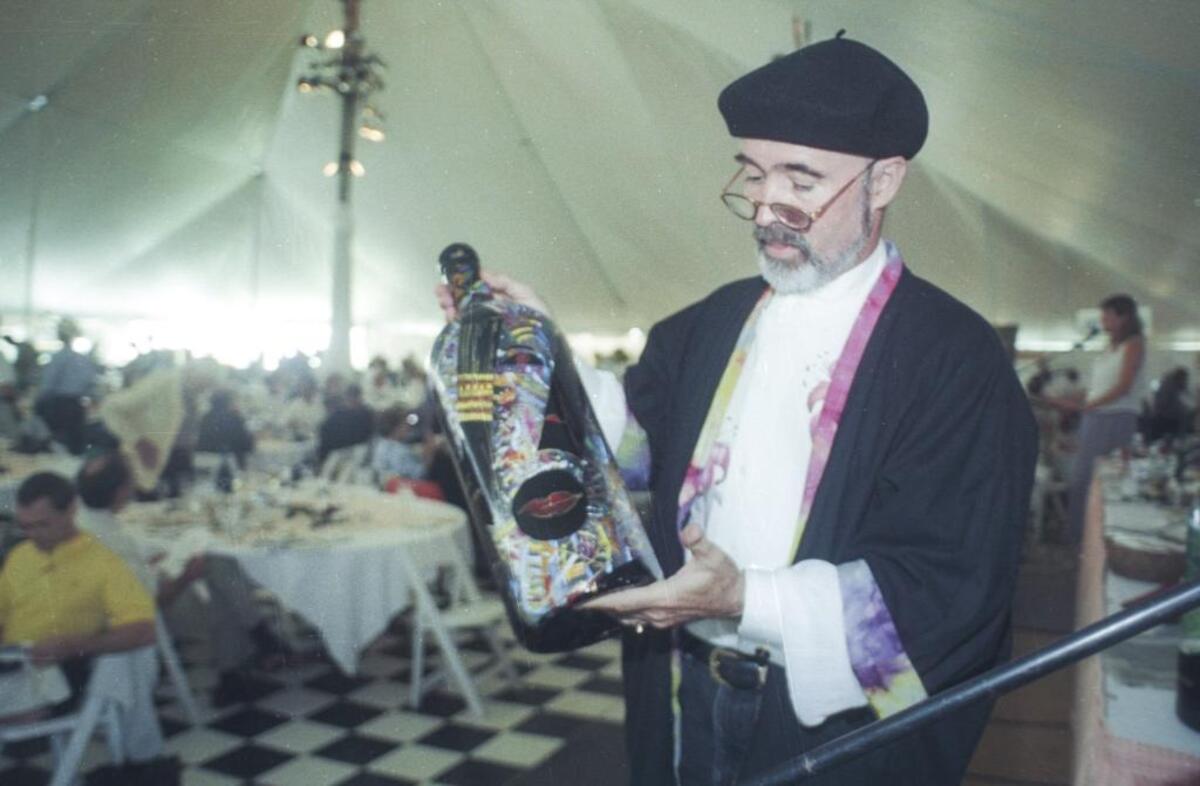 Archie McLaren holds a bottle of McKeon-Phillips Baileys Private Reserve cabernet sauvignon 1995 at the KCBX wine auction on July 12, 1997.