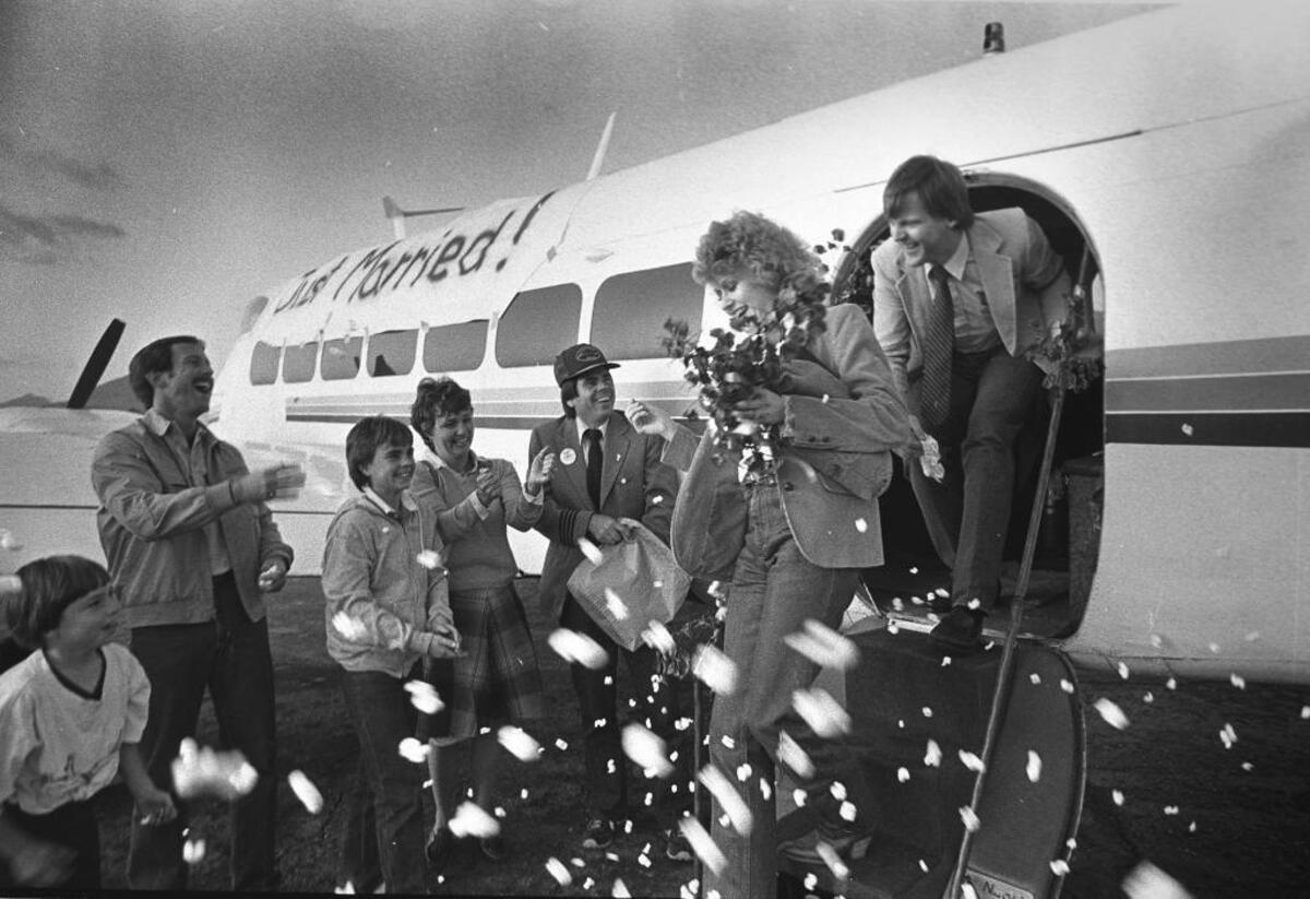 1982: Former Swift Aire pilot Fredd Driggs and Martha Estrada are greeted by friends after their wedding aboard one of the planes on Dec. 1, 1982.