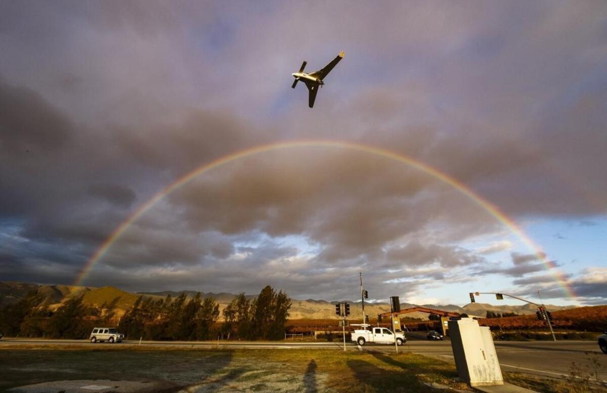 2015: An airplane flies over a full rainbow as it lands at the San Luis Obispo County Regional Airport on Nov. 25, 2015.
