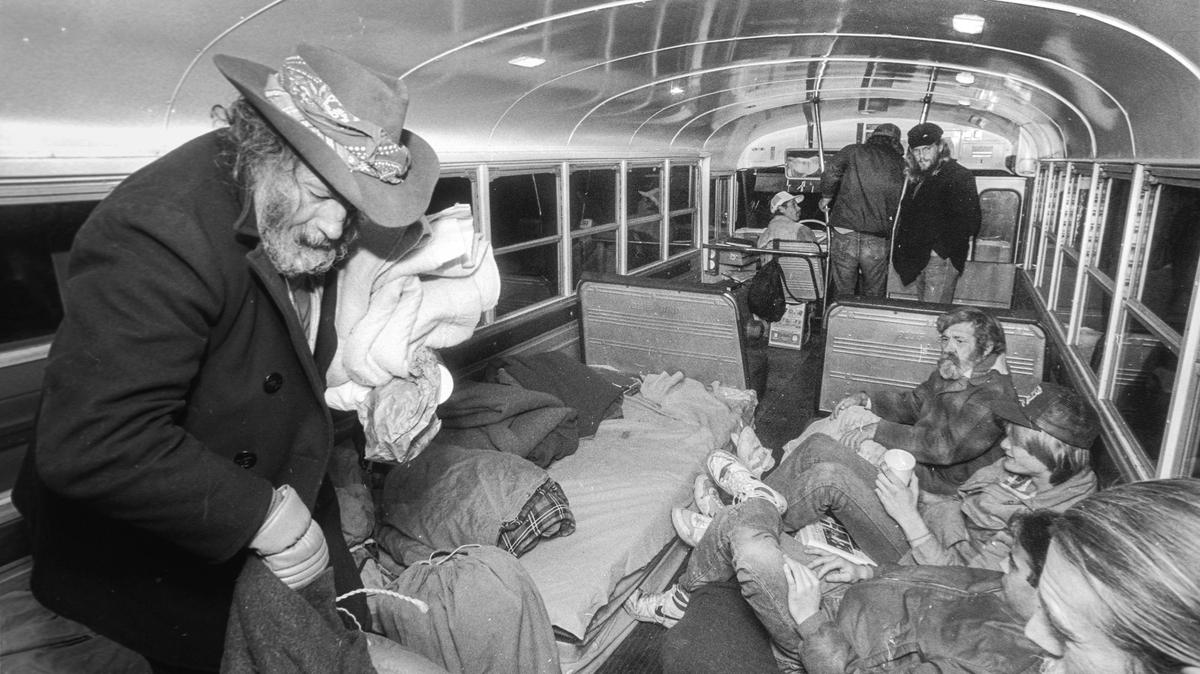 Gabriel Sweeney III, left, gathers his things after the Zedakah House bus stops at El Chorro Regional Park north of San Luis Obispo in 1988. Sweeny prefers sleeping outdoors to using the church shelters.