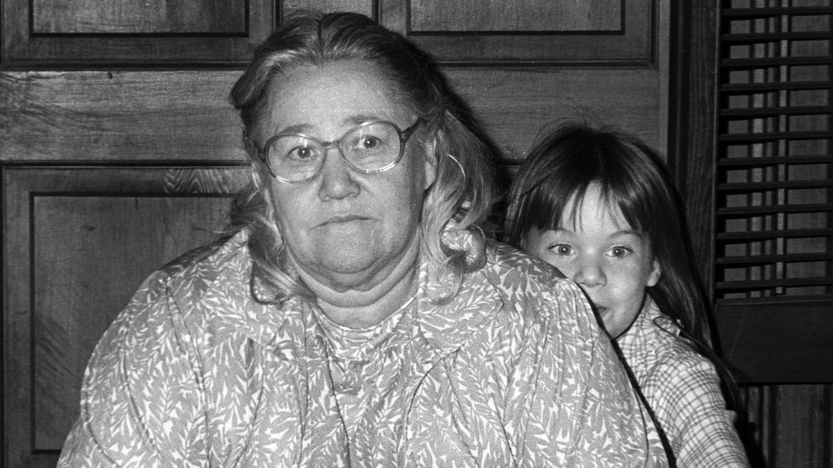 Charity Silva peaks out from behind a somber Stella Randall. The Randall and Silva families were touched by tragedy when a church van carrying several family members was hit by a a trailer truck near Lemoore. 10-25-1982 David Middlecamp