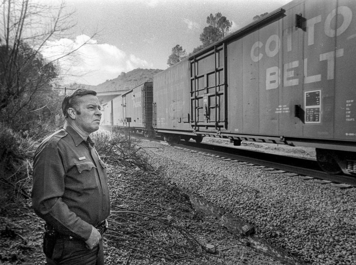 Border Patrol Officer Edward Tuffly watches a Southern Pacific freight train pull into San Luis Obispo.