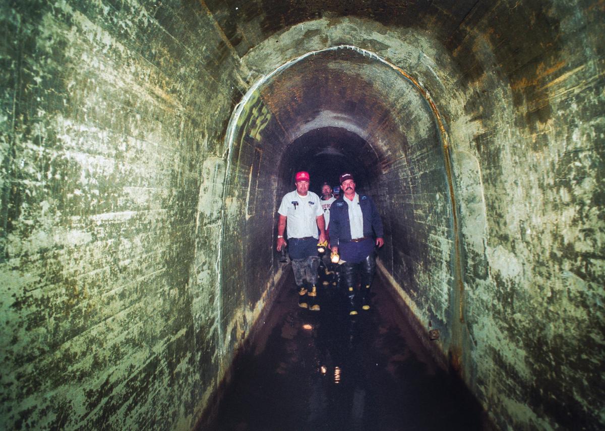 Richard Brown, left and Dick Oliveria lead a tour through the Cuesta Tunnel in 1994. It’s usually filled with water for San Luis Obispo from Salinas Reservoir.