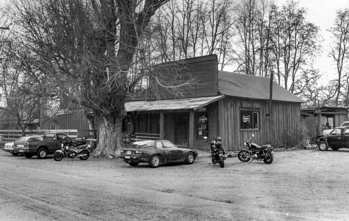 A huge cottonwood tree dwarfs the Pozo Saloon, where porsches and BMWs compete with cowpokes’ trucks in a 1987 photo.