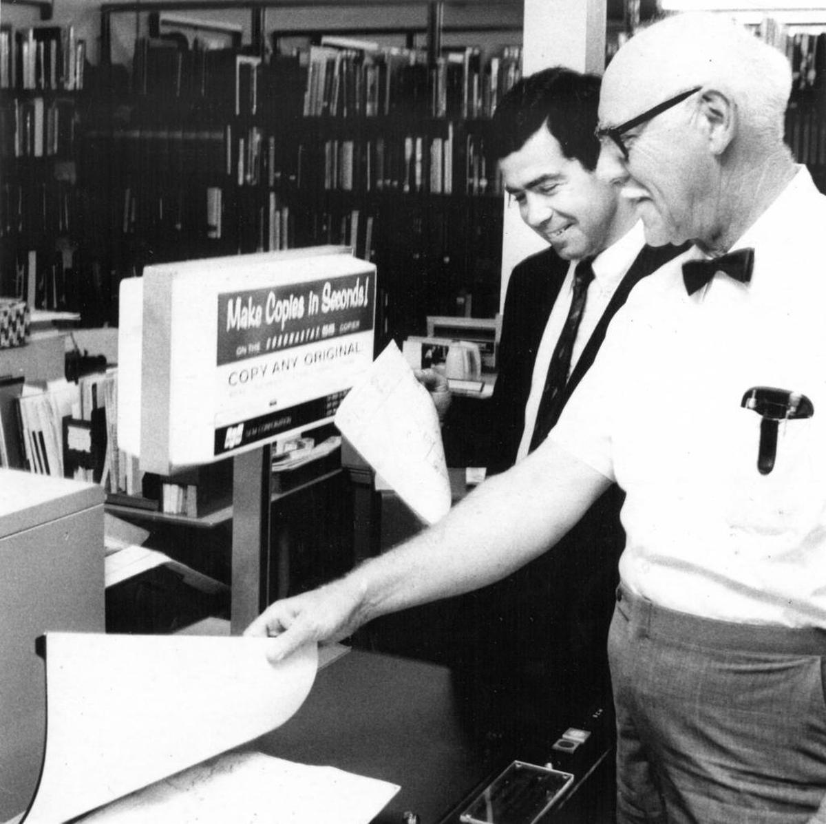 Howard Schornagle, right, demonstrates the county library’s copying service while Jack Mitchell checks map reproduced by machine circa 1969 Telegram-Tribune