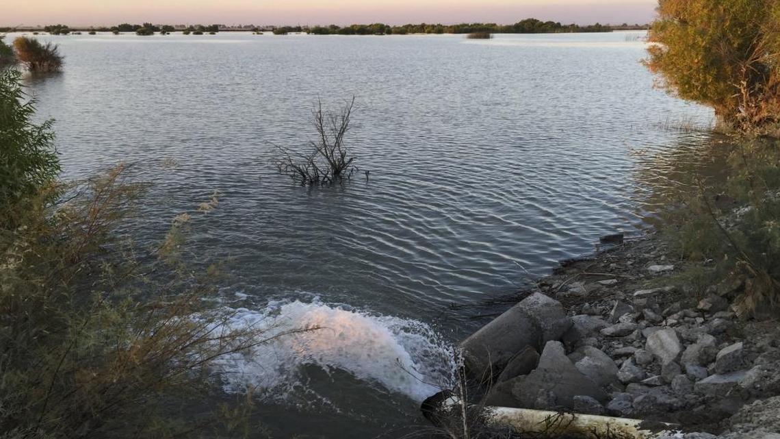 Sunset over an irrigation pond filled via adjacent wells near Alpaugh. Most of the former Tulare Lake is farmed or lies fallow when water is not available.
