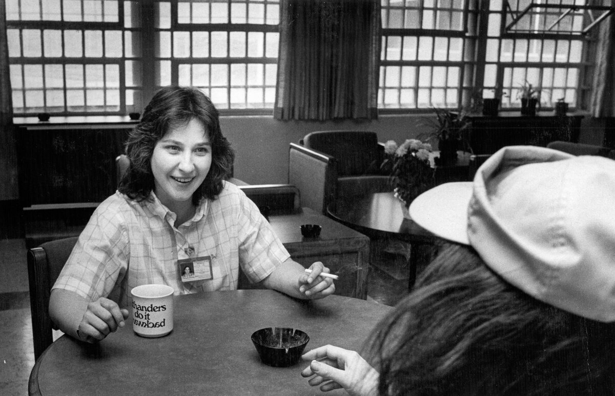 Psychiatric technician Tracy Jensen talks to one of her 26 patients at Atascadero State Hospital, the world’s largest hospital for the criminally insane in 1987. Sharing a cigarette was the ultimate gesture of kindness inside ASH at the time; tobacco has since been banned.