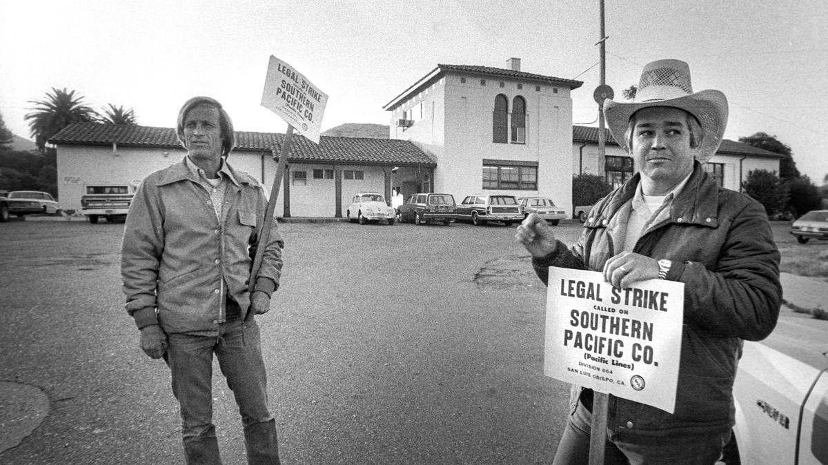 Southern Pacific Railroad engineers Don Lessi, left, and Bob Swain walk the picket line on the morning of Sept. 20, 1982, during a strike at the train depot in San Luis Obispo.