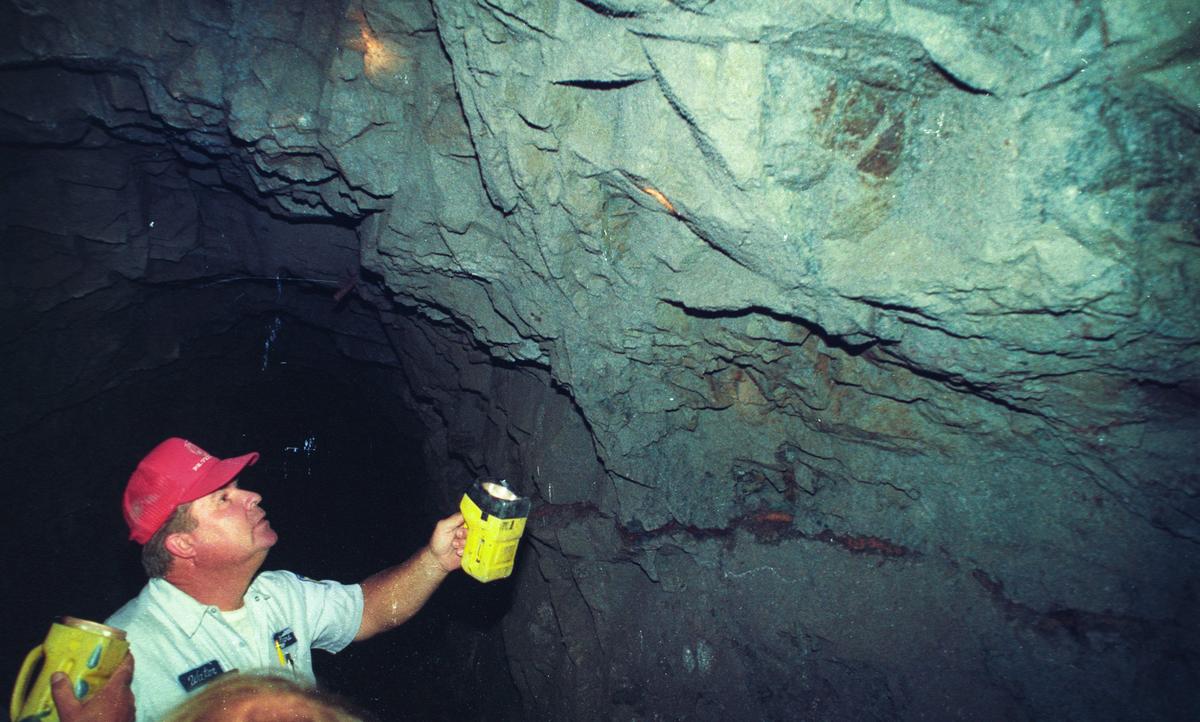 Richard Brown looks where some of the ceiling has fallen away during a 1994 tour of the Cuesta Tunnel, which carries water from Salinas Reservoir to San Luis Obispo.