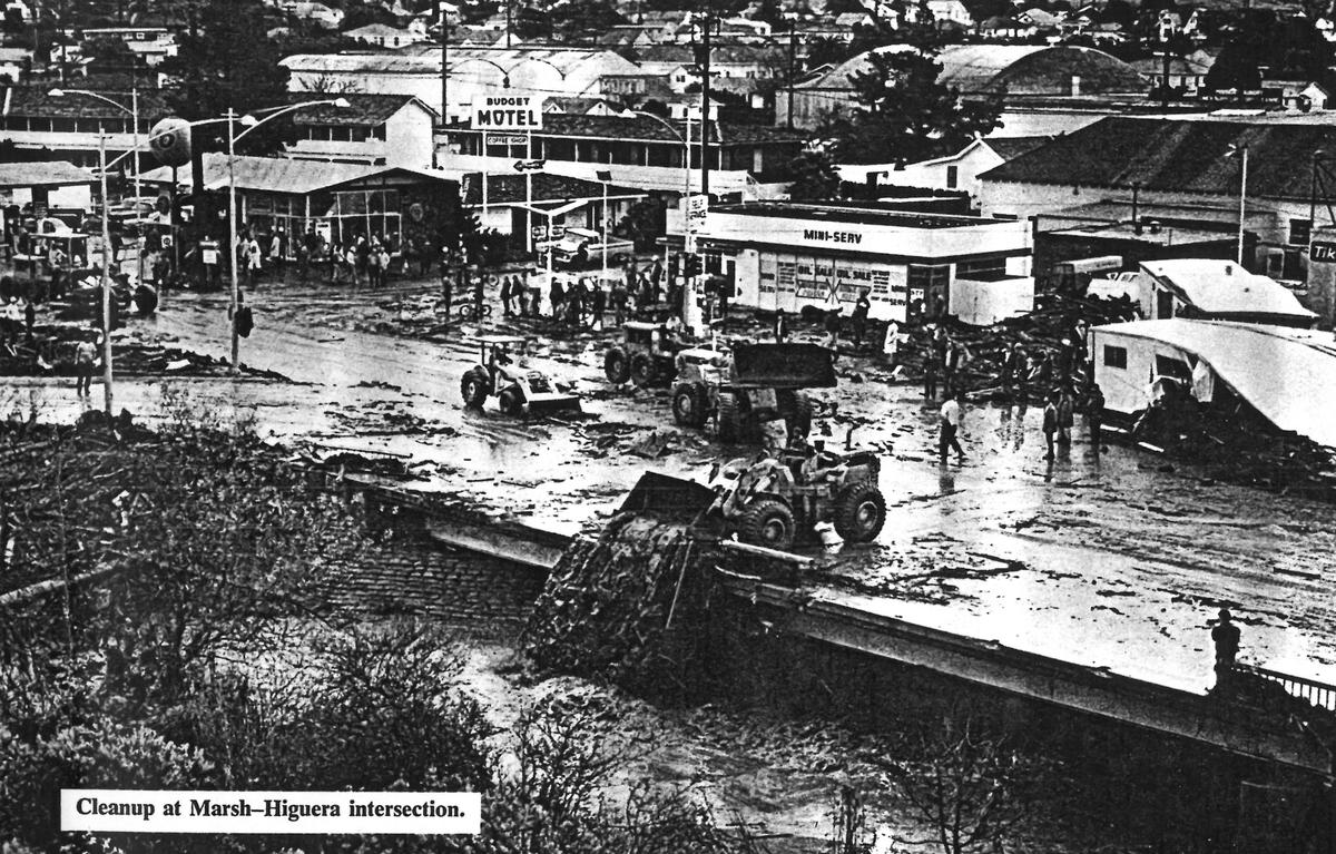 Marsh and Higuera is covered with mud and mobile homes as buckets of mud are dumped into San Luis Creek after the January 1973 flood.
