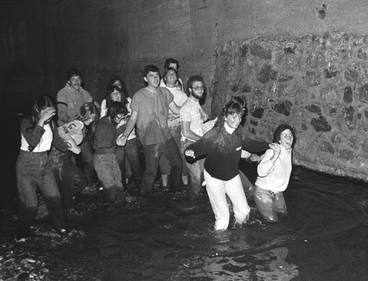 New Cal Poly students take part in the Week of Welcome’s Sewer Tour, a walk through San Luis Creek under the town in 1982.
