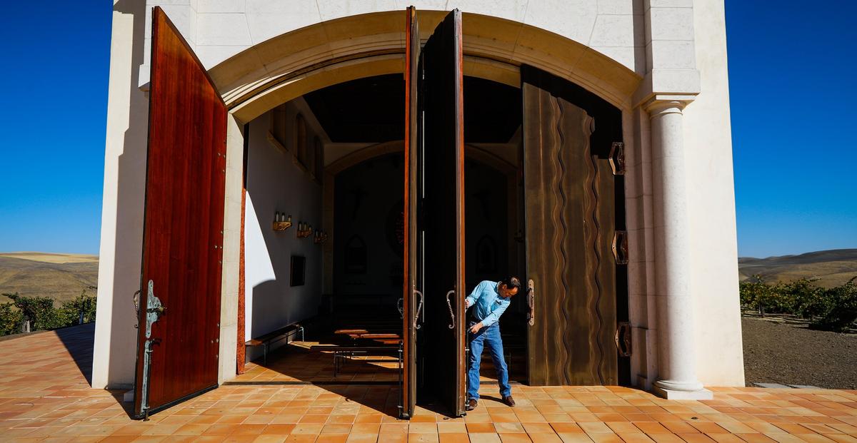 Paul Clark closes the massive doors of the Serra Chapel in Shandon. Photo by Joe Johnston 11-08-18