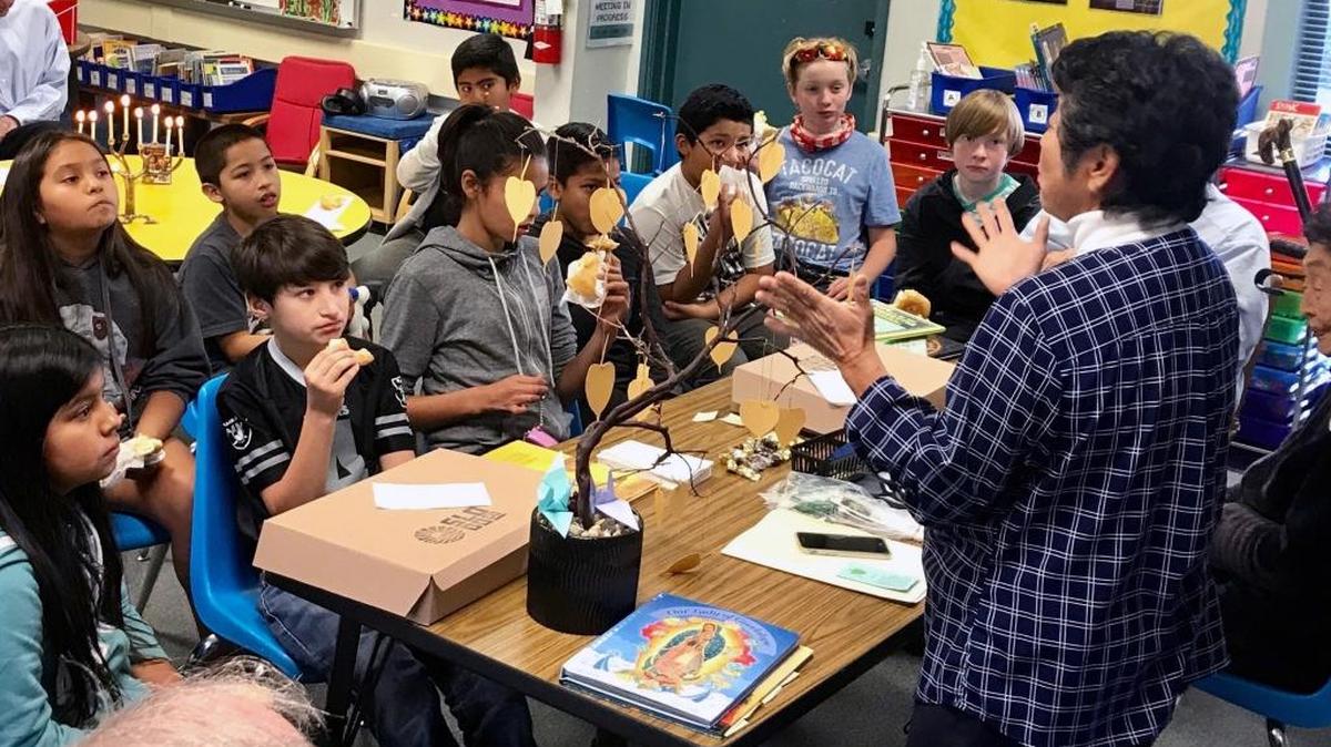 Janis Eto with a Bodhi Tree speaking of the Buddha’s golden chain of love that stretches around the world to students at Hawthorne Elementary School in San Luis Obispo.