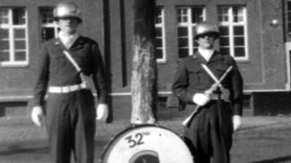 Jack Pierce, in glasses, stands outside the 7701 st U.S. Army Europe (USAREUR) Band School barracks at Dachau, Germany, in 1951.