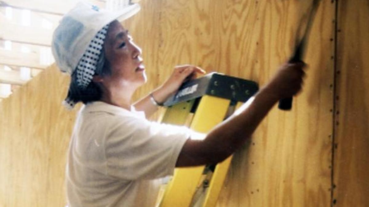 Yoshiko Tachibana hangs drywall at Antioch United Holy Church in Rocky Point, North Carolina.