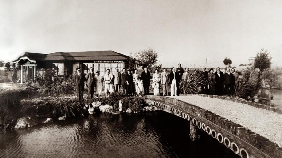 The Shibata family and friends are seen in front of the gardens and bridge at Mt. Eden Nursery near Hayward in 1941.