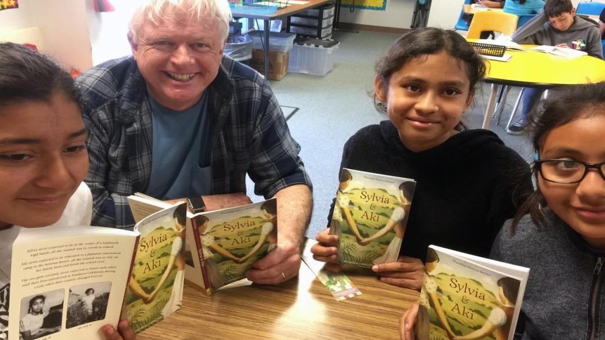 Volunteer John Knox reads “Sylvia & Aki” with (left to right) students Yoselin, Amy and Elbia in Laura Kirschner’s class at Hawthorne School in San Luis Obispo.