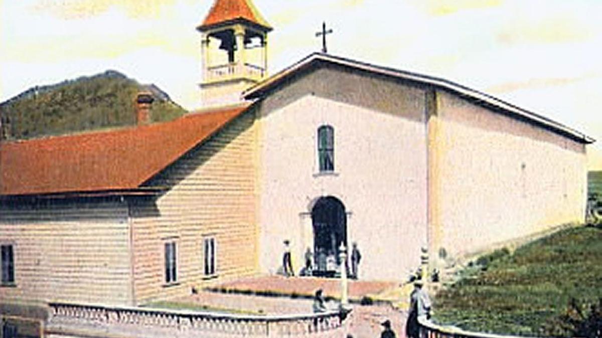 The Mission encased in clapboard with the New England style bell tower, circa 1920.