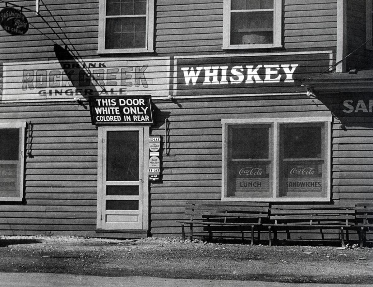“White only” signs like this one, shot in Maryland in the 1930s. by Atascadero photographer Joe Schwartz, were once common in the U.S. They’ve been removed, yet “white only” language has never been expunged from our real estate documents.