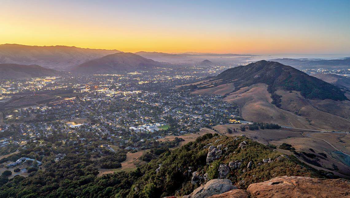 The sun rises over San Luis Obispo in a view from the top of Bishop Peak.