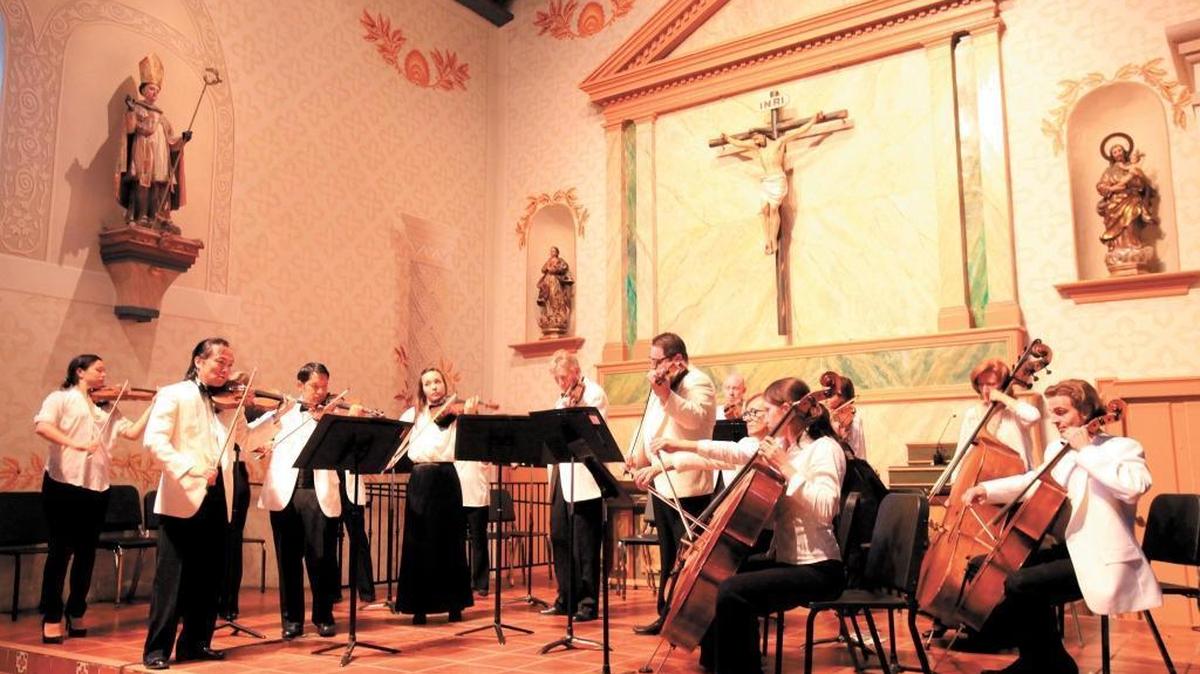 Festival Mozaic music director Scott Yoo, front row, far left, leads the orchestra in concert at Mission San Luis Obispo de Tolosa in 2013. A series of chamber music concerts are planned for Festival Mozaic’s 2023 Summer Music Festival.