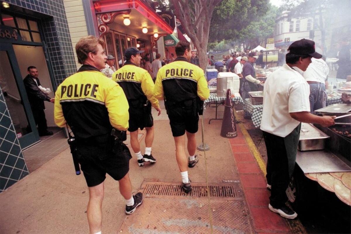 Former longtime San Luis Obispo policeman Bill Proll (middle) on patrol at the downtown farmers market in 2002. Also pictured is Eric Lincoln (left) and Ian Parkinson (right).